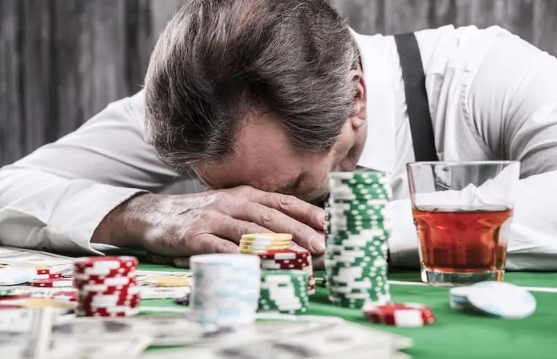 man-sad-face-down-on-table-gambling-problem