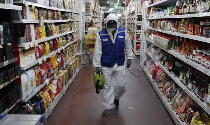 man-protective-gear-disinfection-ailes-supermarket-covid-safety