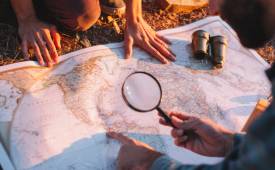 men-exploring-map-treasure-hunting
