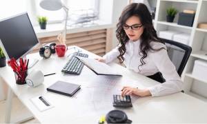 businesswoman-sitting-office-desk-calculator-accounts-payable-fraud