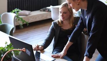 two-businesswomen-using-laptop-increase-business-growth