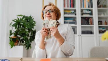 woman-happy-holding-money-dolar-notes-etiquette-of-borrowing-money