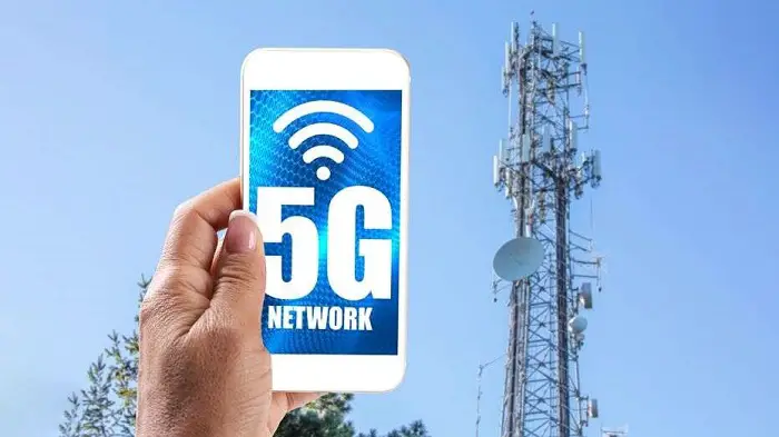 5g_cell_tower_with_woman_holding_mobile_phone.jpg