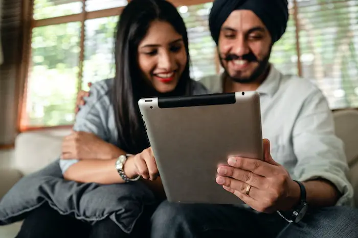 indian-couple-reading-online-on-tablet