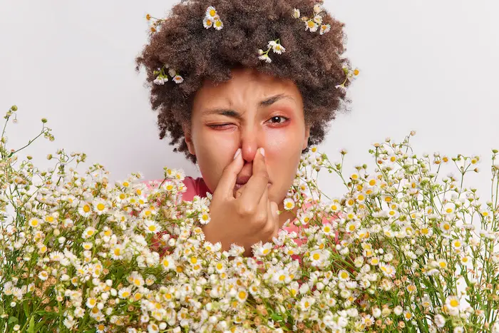 woman-holds-nose-allergy-big-bouquet-flowers-has-red-itchy-eyes.jpg